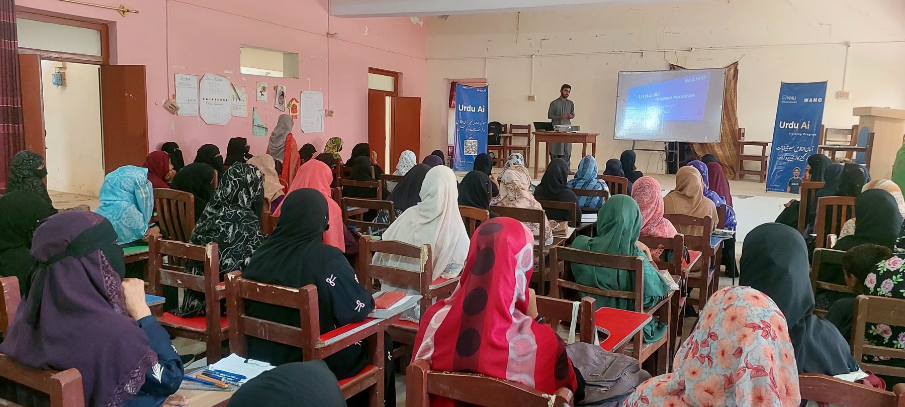 Women attending an Urdu Ai teacher training session in a classroom